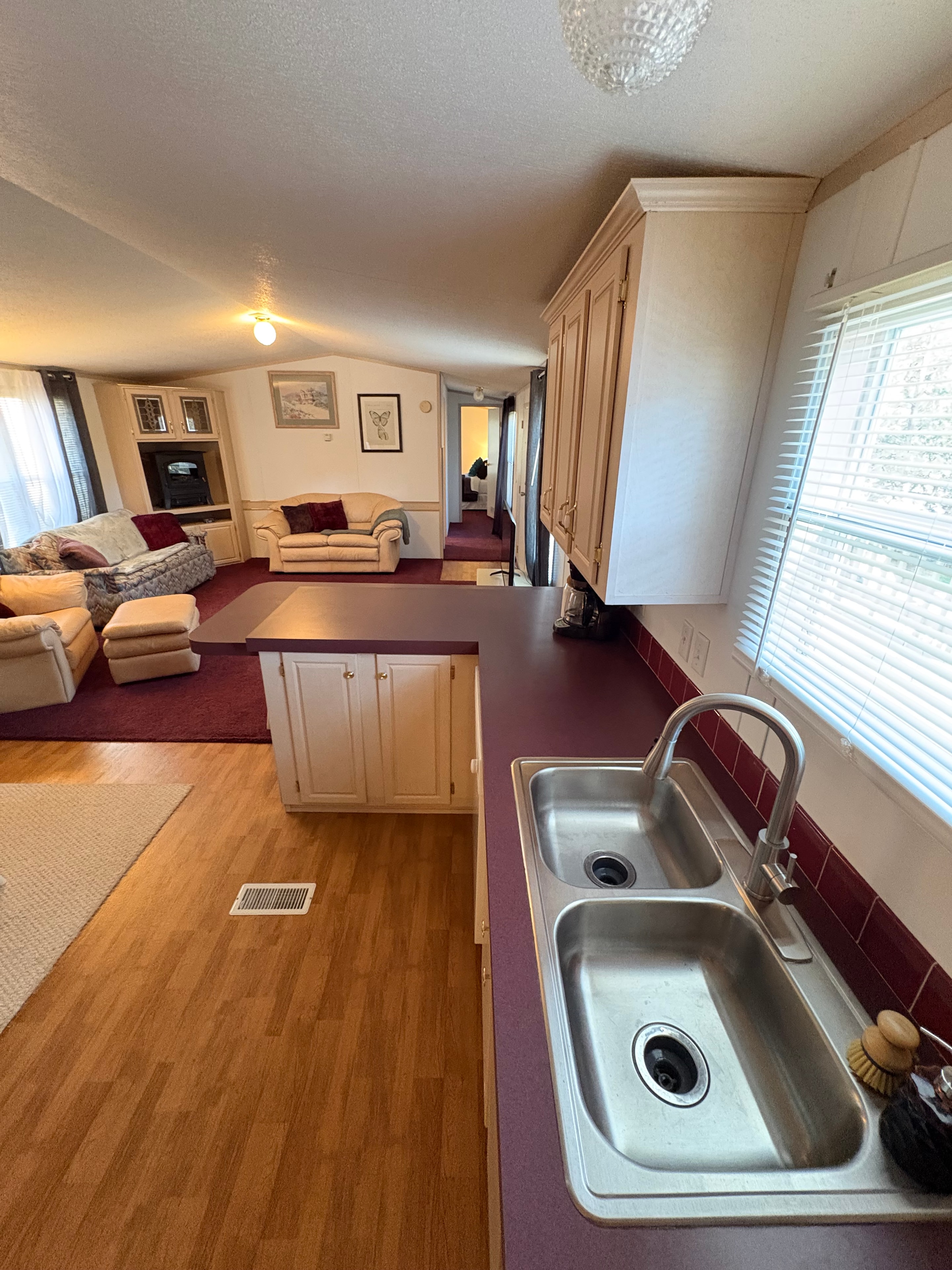 Airbnb kitchen and living area with warm wood flooring